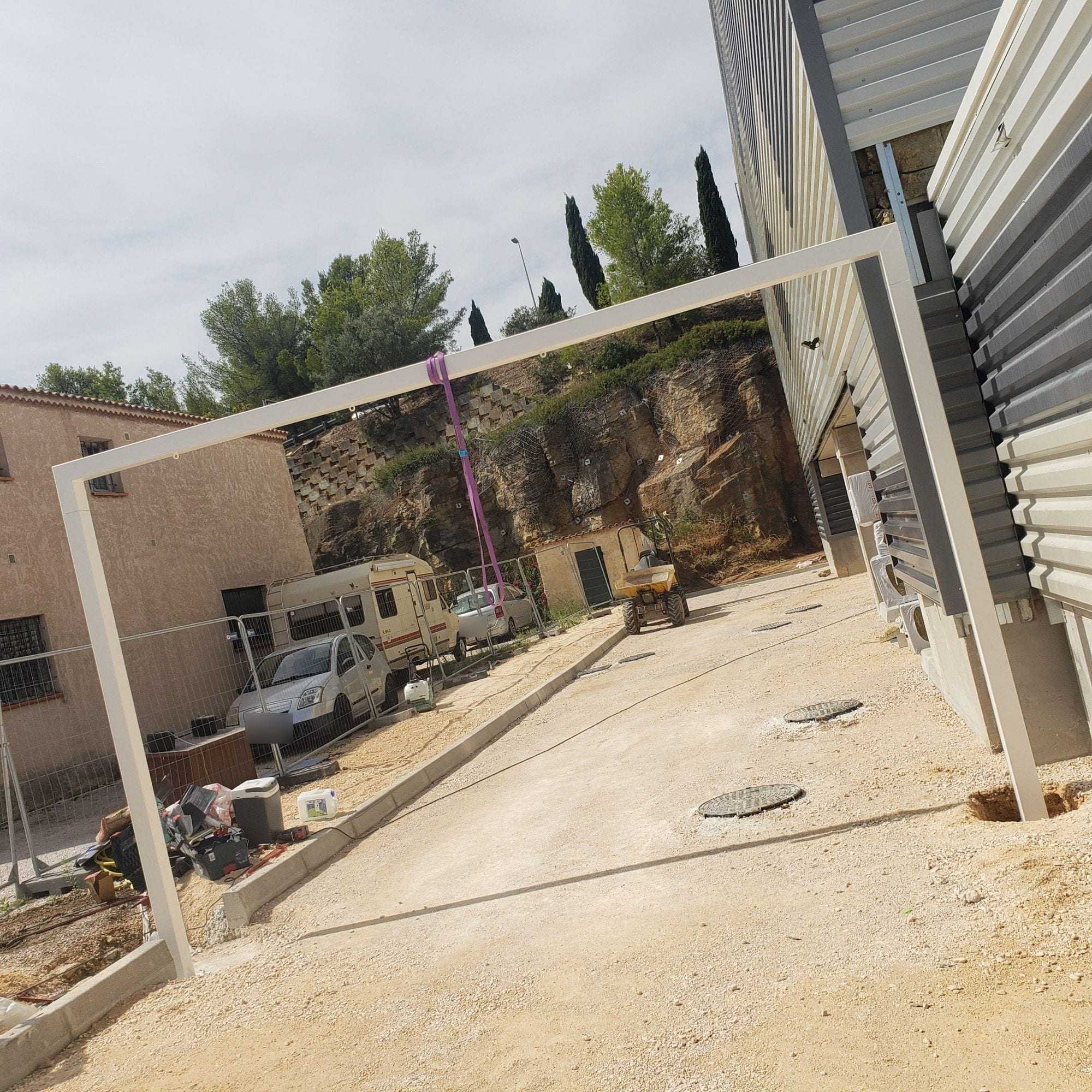 White pergola frame set up on a building site