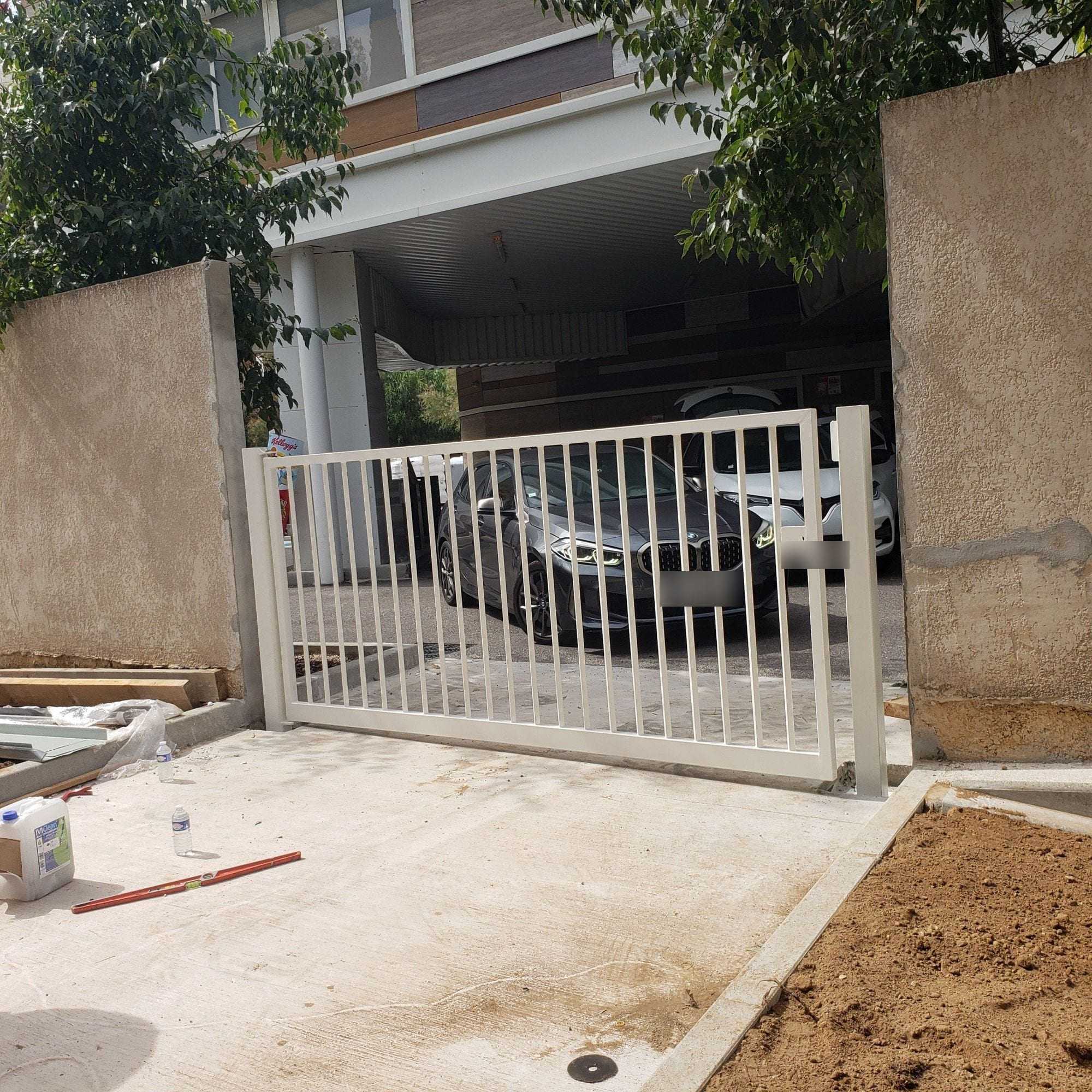 White sliding gate installed, vertical bars